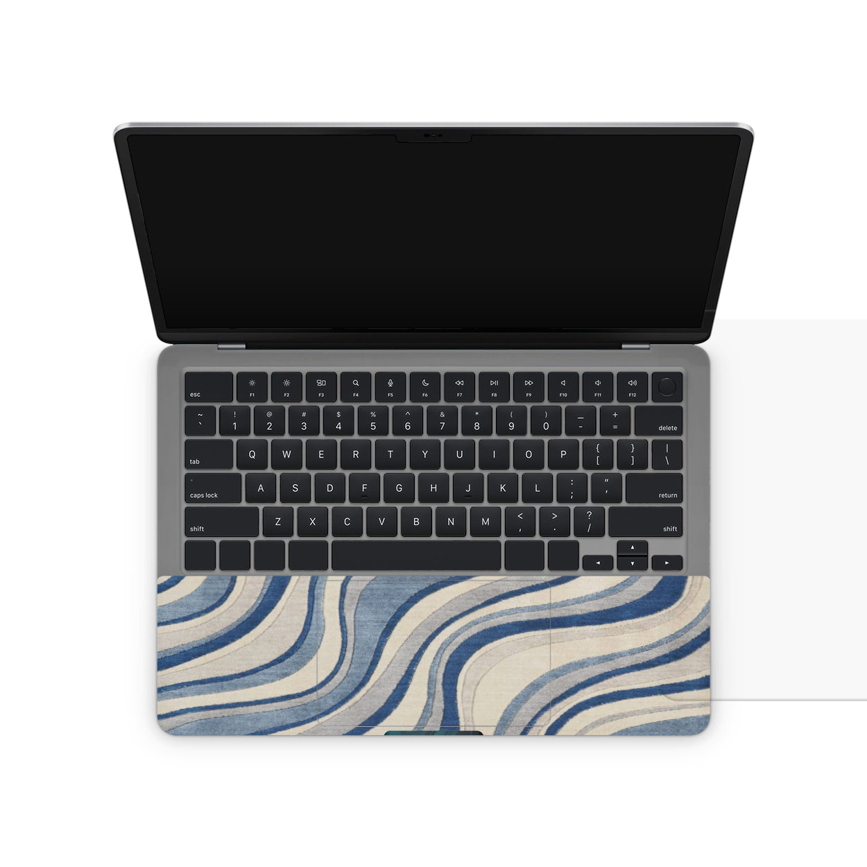 Laptop with a blue and white wavy patterned cover on a white background