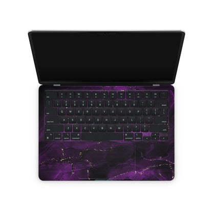 macbook skin with purple ink design on keyboard area
