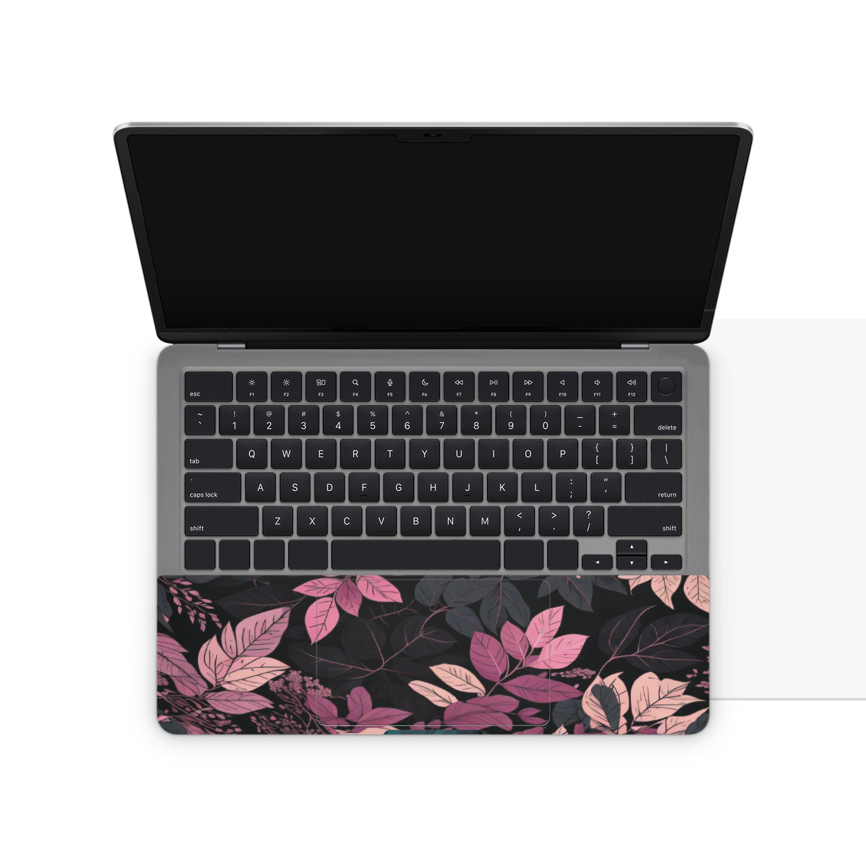 Laptop skin with pink and purple leaf pattern on touchpad area