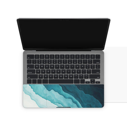 Laptop with a blue and green abstract design on the bottom half of the screen