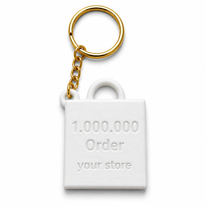 Back side of 3D printed Shopify 1 million order keychain with “your store” text and gold keyring